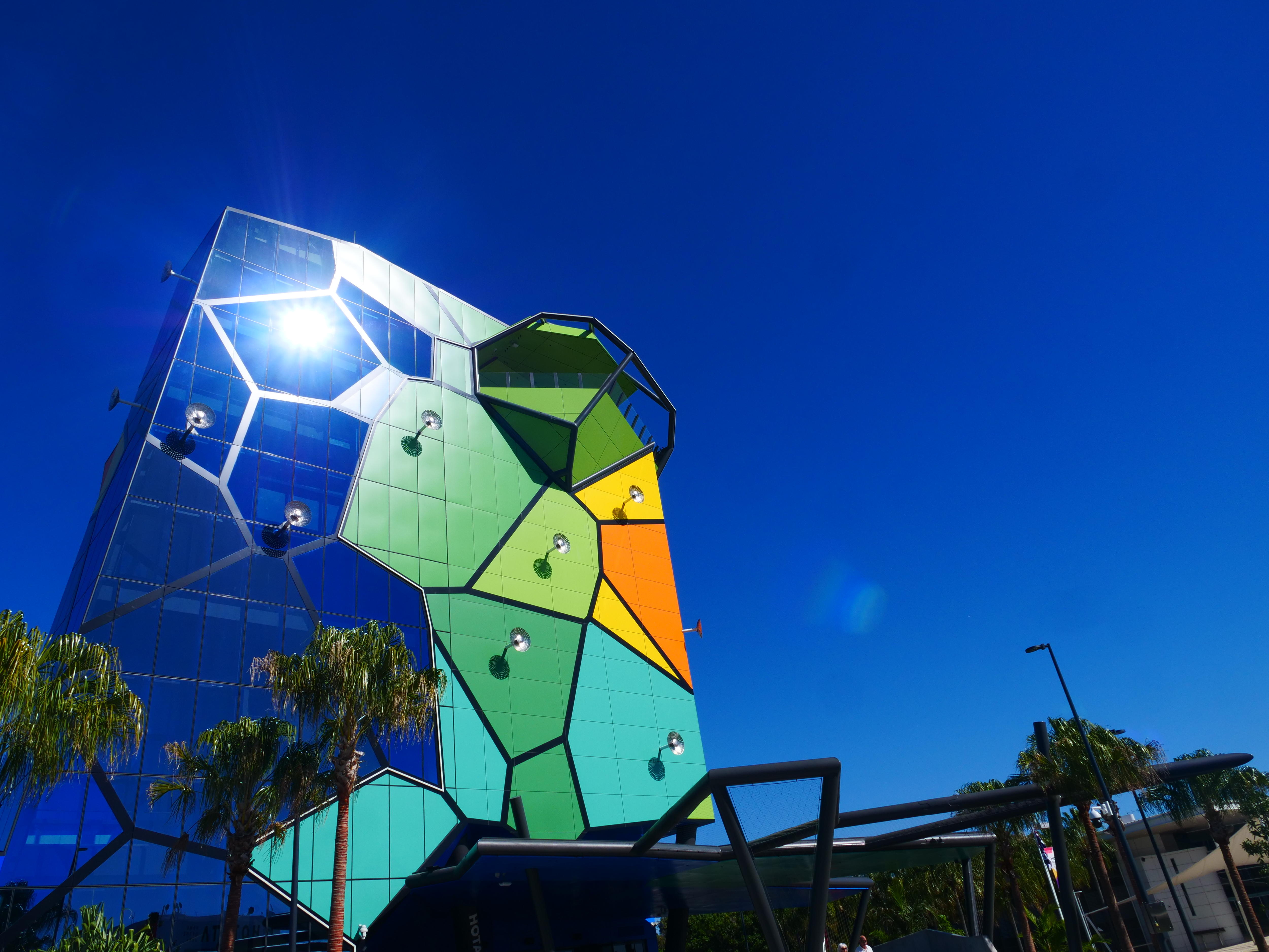 A brightly coloured building against a blue sky.
