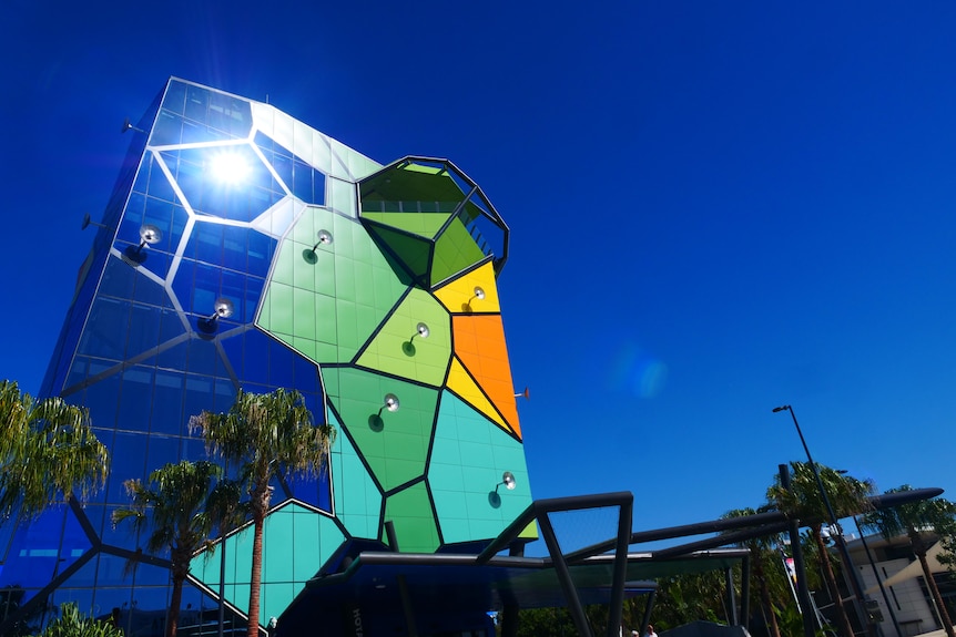 A brightly coloured building against a blue sky.