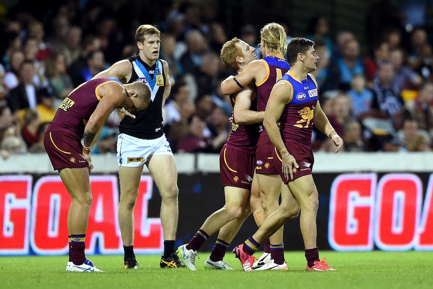 Brisbane's Josh Green (C) celebrates his goal against Port Adelaide with team-mates at the Gabba.