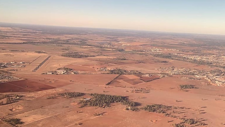 An aerial view of brown land.