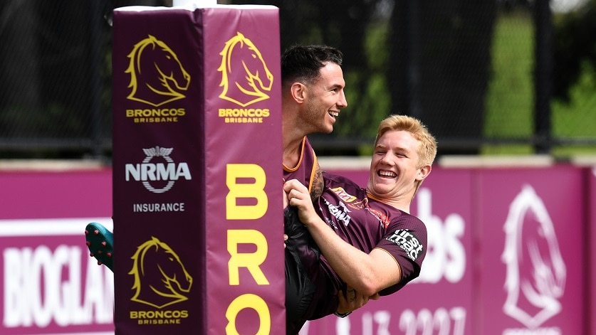 Darius Boyd holds a laughing Tom Dearden in his arms