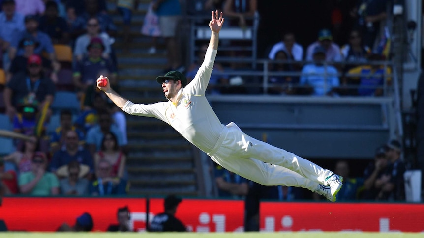 Australia's Kurtis Patterson grabs the ball out of the air while spread eagled during a Test against Sri Lanka at the Gabba.