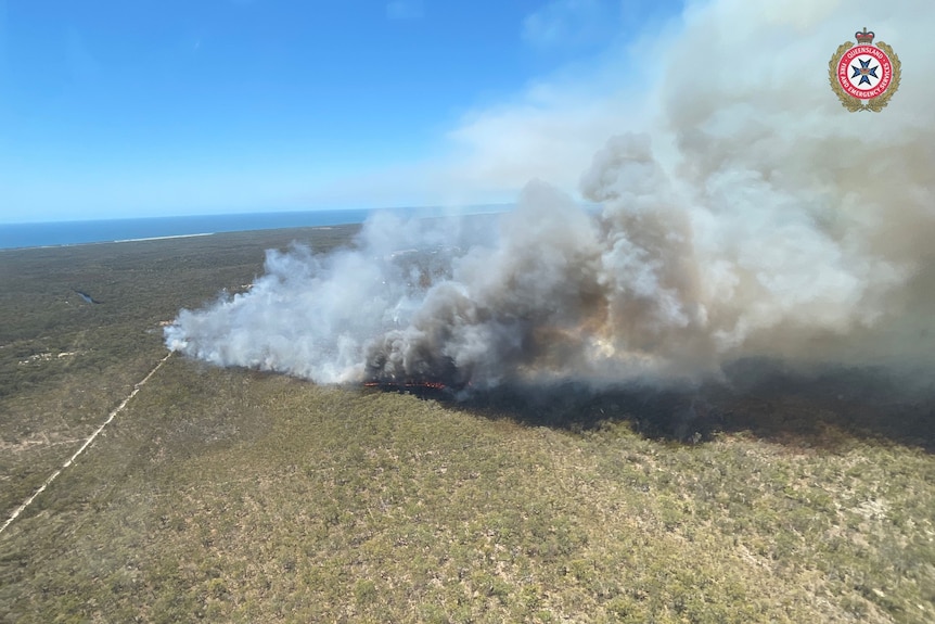 An aerial view of a bushfire burning in a rural area.