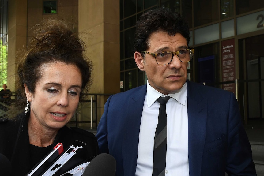 Vince Colosimo walks out of court with his lawyer.