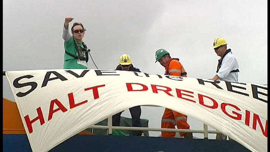 An activist also chained himself to a dredging barge for around 40 minutes before being removed by police.