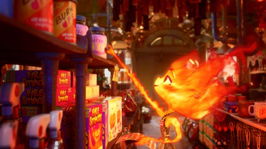 A flame creature from the movie Elemental grabs something off the kitchen shelf