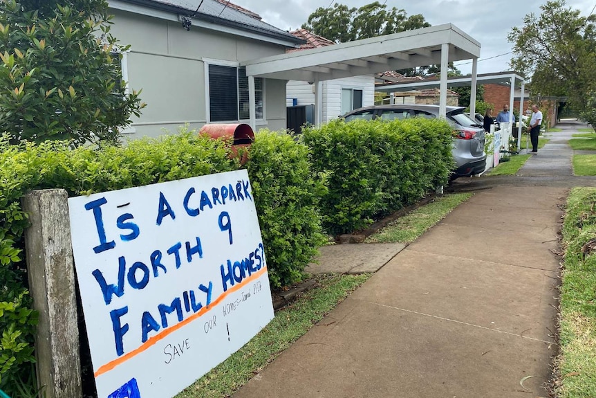 A sign outside a house reads is a car park worth nine family homes