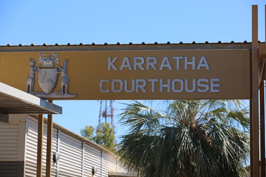 Karratha courthouse sign against a blue sky.