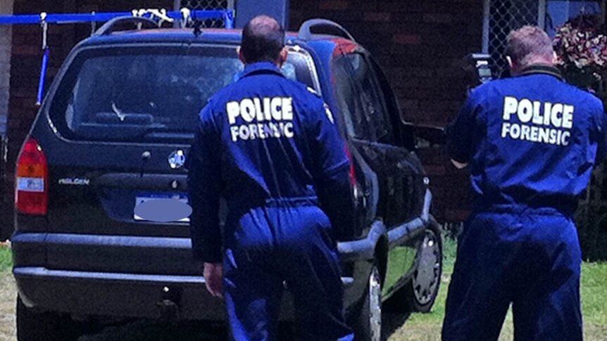 Forensic police examine shot car