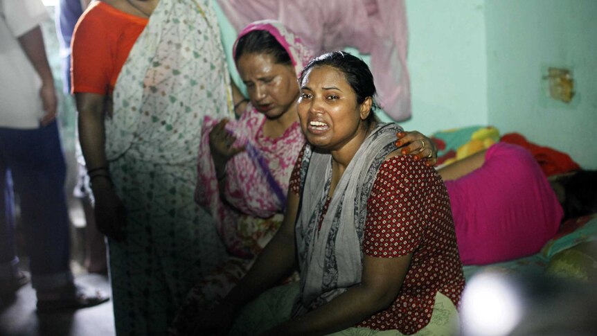 The wife (R) of murdered Bangladeshi blogger Niloy Chatterjee, who used the pen-name Niloy Neel, weeps at their home