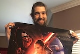 Daniel Fleetwood holds Force Awakens poster