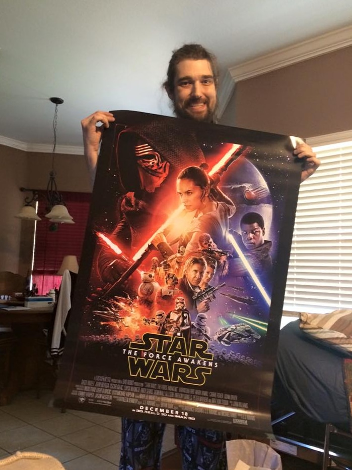 Daniel Fleetwood holds Force Awakens poster