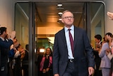 People line the corridors to applaud Anthony Albanese as he walks down the middle of a corridor