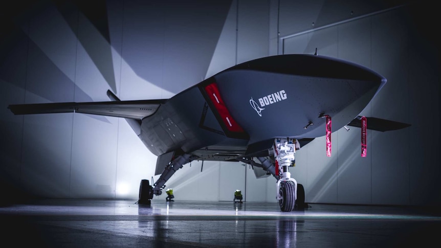A large jet-like drone in a hangar.