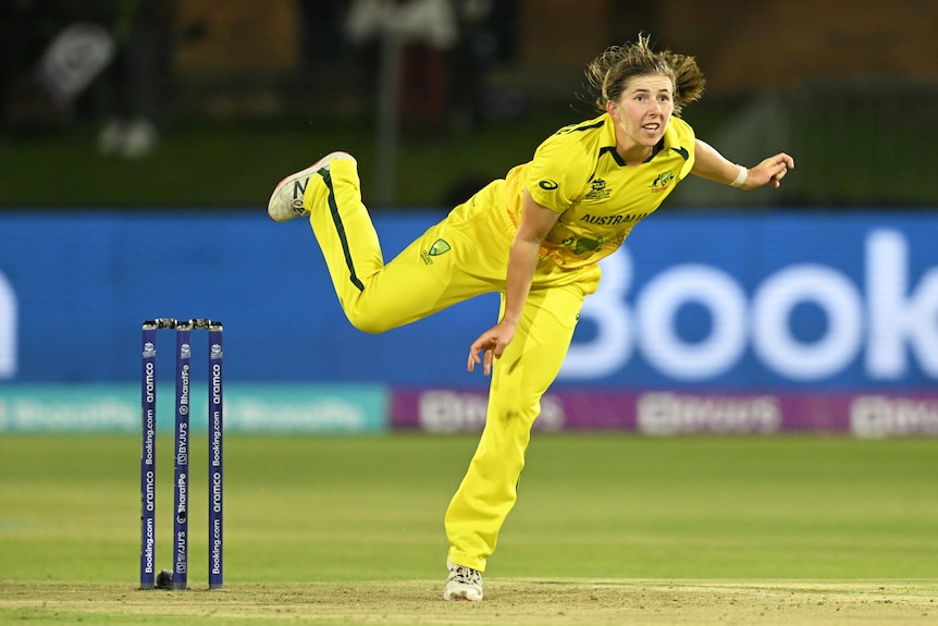 An Australian bowler looks down the pitch in her follow-through after delivering the ball in a T20 international. 