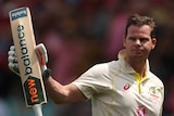 Australia batter Steve Smith holds up his bat as he walks off the field during a Test against South Africa at the SCG.