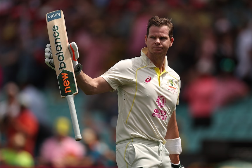 Australia batter Steve Smith holds up his bat as he walks off the field during a Test against South Africa at the SCG.
