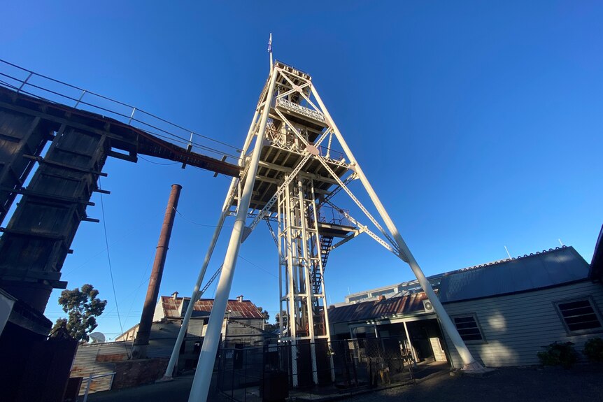 A white poppethead, a tall structure, used for mining back in the Goldfields era. 