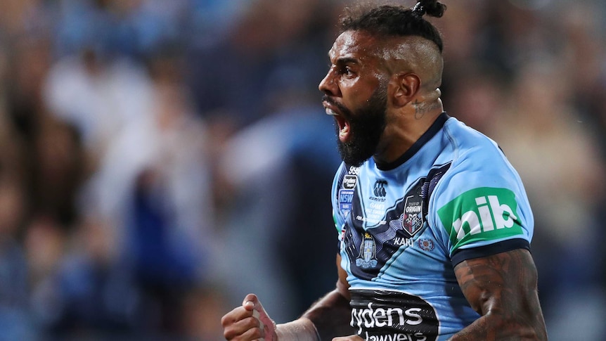 NSW Blues player Josh Addo-Carr pumps his fists and yells after a try.