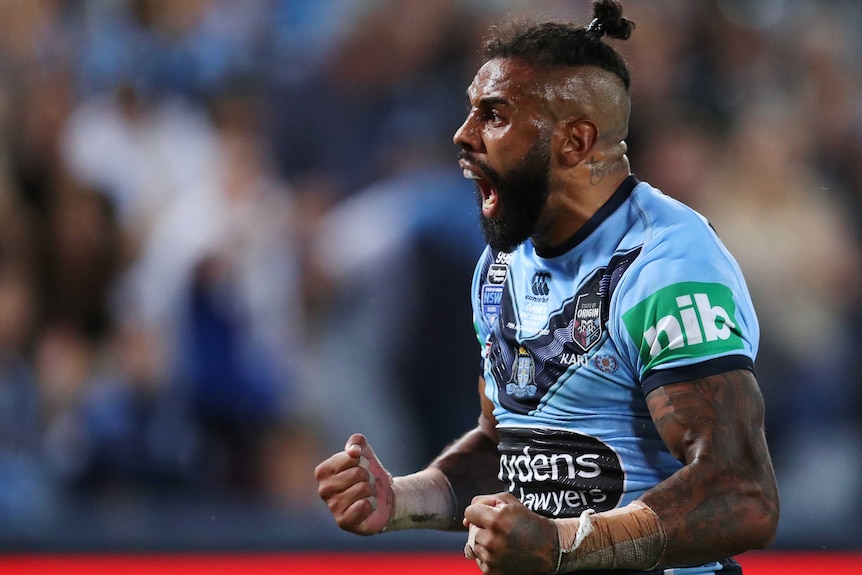 NSW Blues player Josh Addo-Carr pumps his fists and yells after a try.