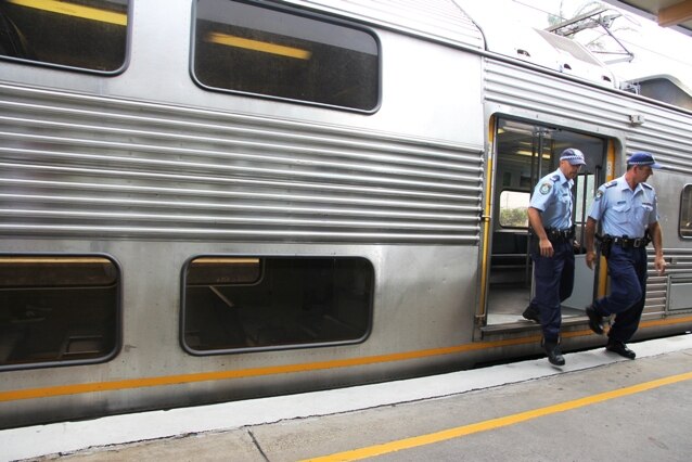 generic NSW Police Transport Command officers get off a train in Newcastle