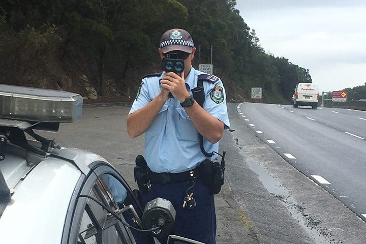 police officer holding speed camera on Wollongong Mt Outsley road 