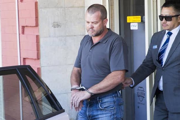 Port Kembla gun shop owner Shane Simpson is arrested by police in 2018