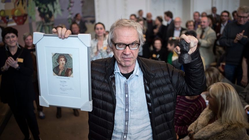  Lars Vilks holds up his Sappho Award plaque after being awarded by Denmark's Free Press Society in 2015.