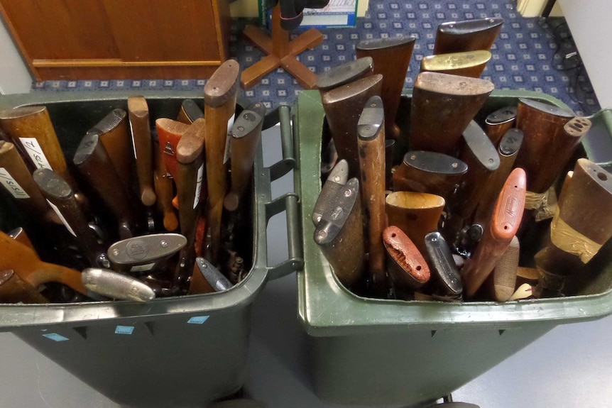 Guns handed in to Tasmanian Police, displayed in bins, in 2017.
