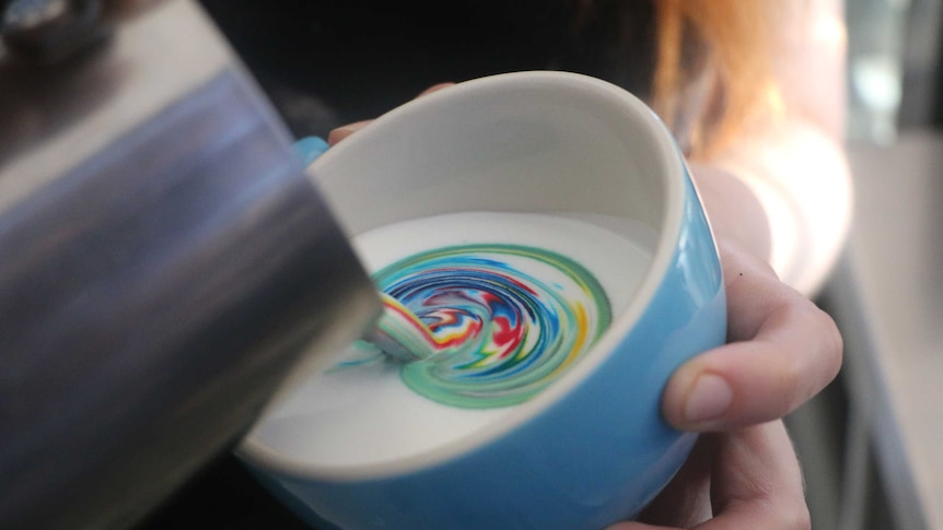 Emily Coumbis pours a Rainbow Coffee