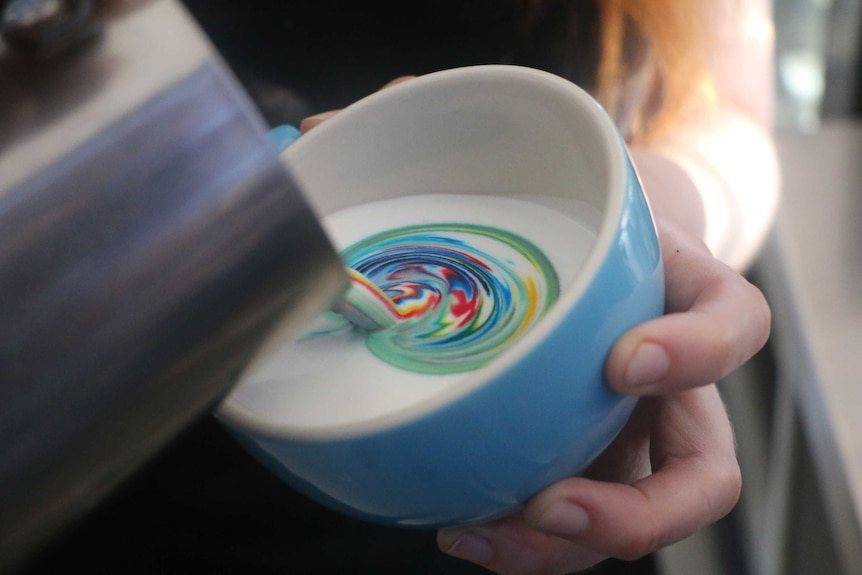 Emily Coumbis pours a Rainbow Coffee
