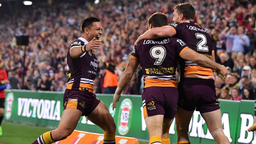 Corey Oates (R) of the Broncos celebrates a try with Ben Hunt and Alex Glenn (L) against Penrith.