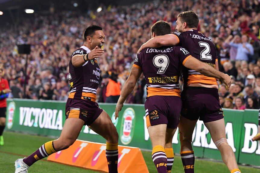 Corey Oates celebrates his try for the Broncos with Ben Hunt and Alex Glenn