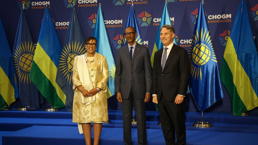 Deputy Prime Minister Richard Marles poses for a photo with two other people