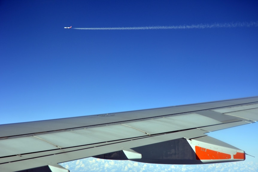 A plane leaves a contrail in its wake.