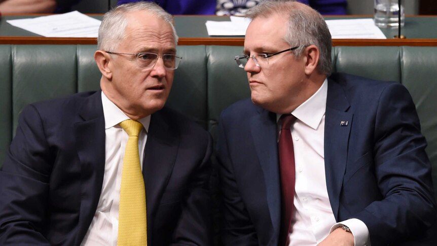 Malcolm Turnbull and Scott Morrison, seated, talking in Question Time