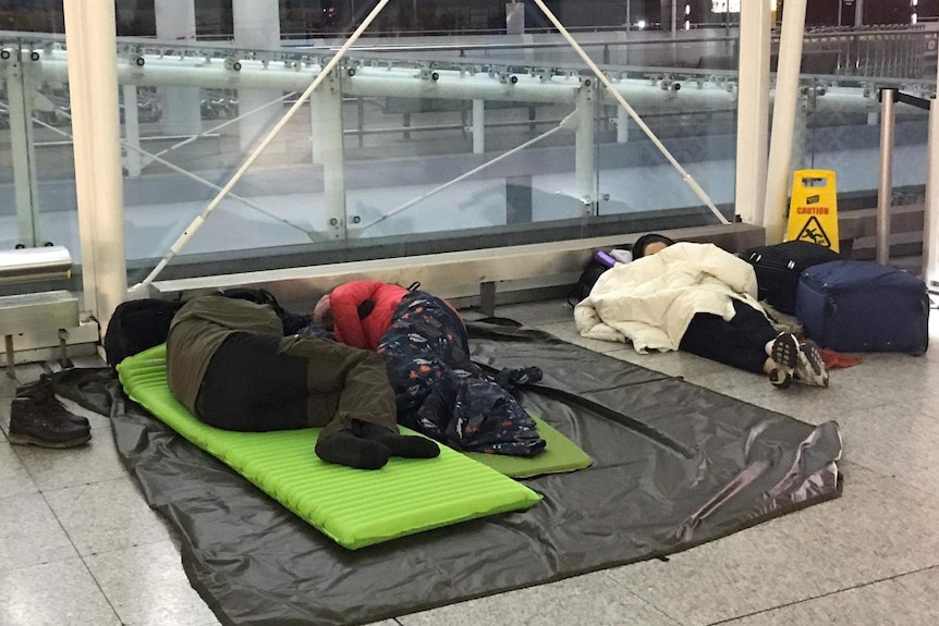 People sleeping on an airport concourse