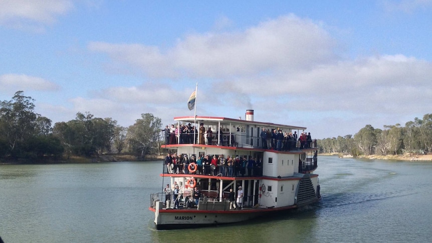 A paddle steamer full of passengers on the Murray River.