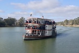 A paddle steamer full of passengers on the Murray River.