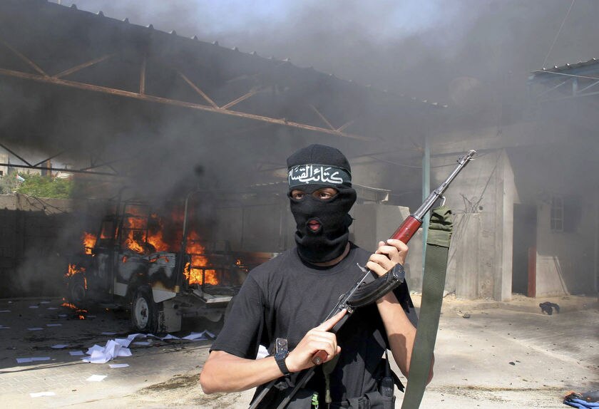 A Hamas fighter takes up position in Gaza