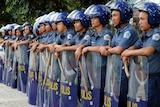 Riot police stand guard for possible protests along a major road near the APEC summit.