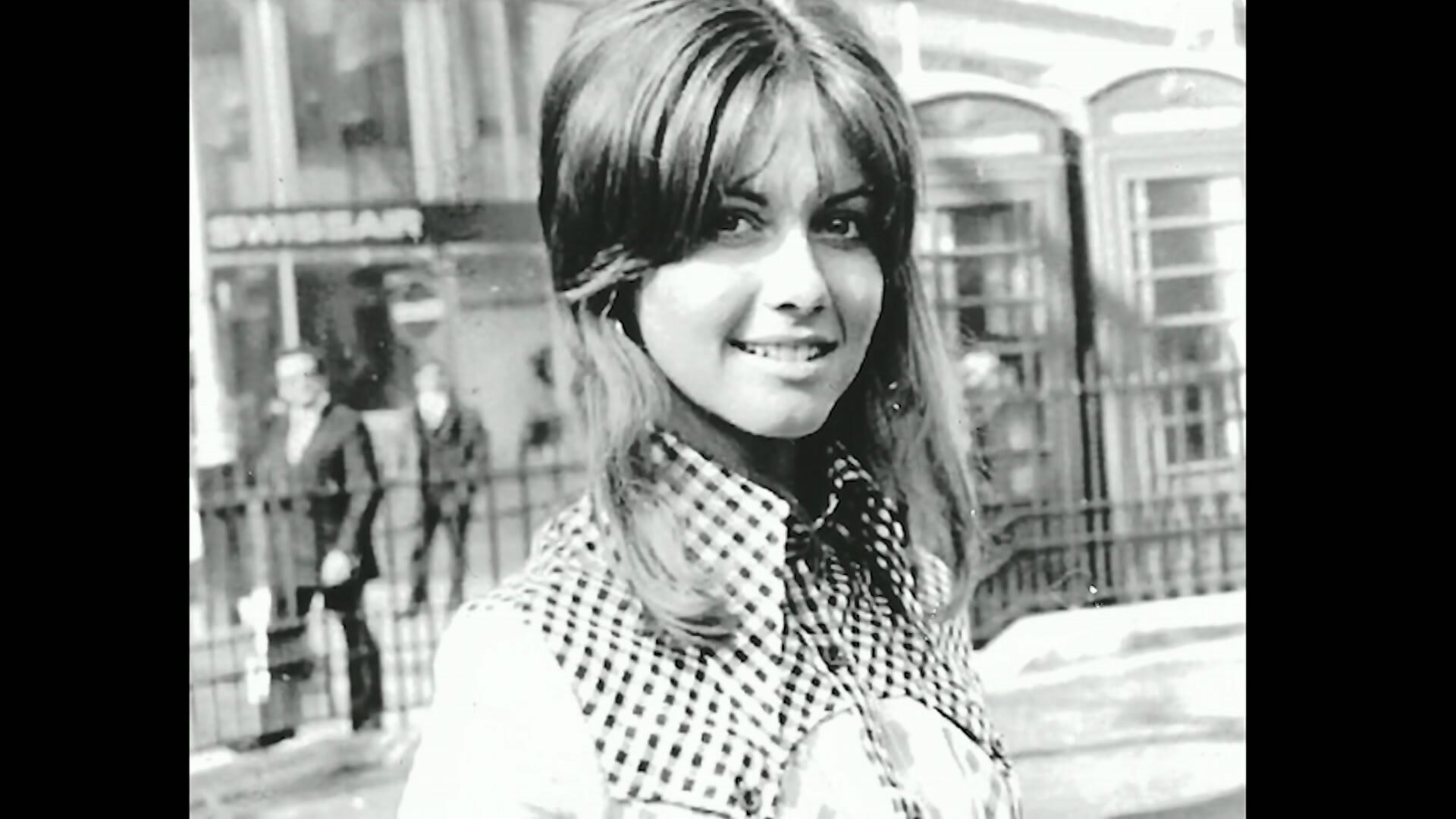 A black-and-white photograph of Olivia Newton-John as a young woman.