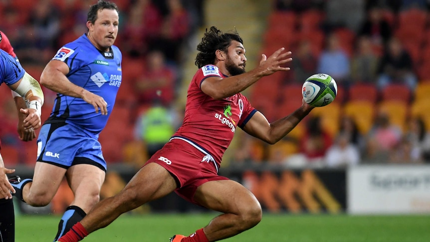 Karmichael Hunt grabs the ball for the Queensland Reds against the Western Force