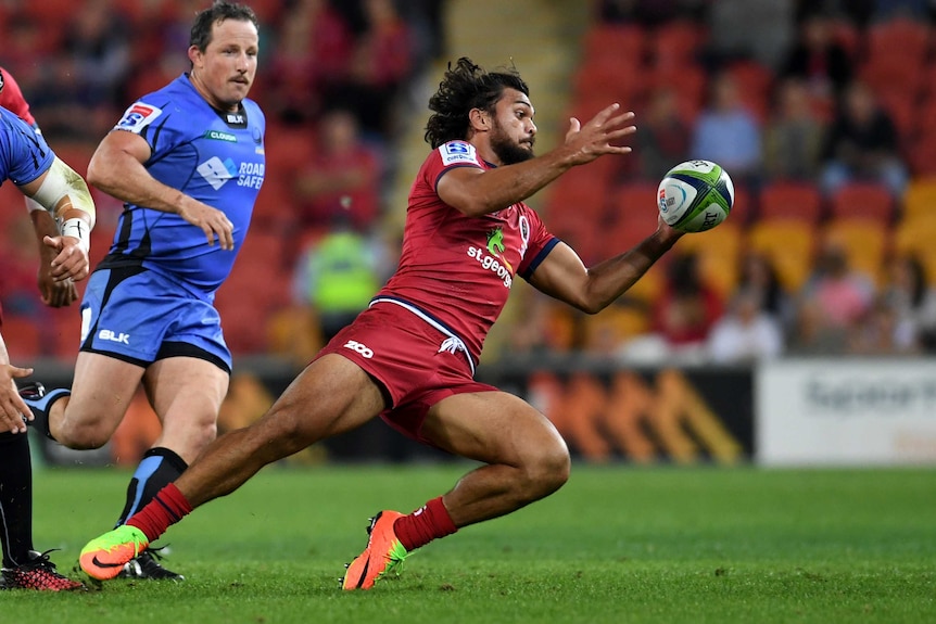 Karmichael Hunt grabs the ball for the Queensland Reds against the Western Force