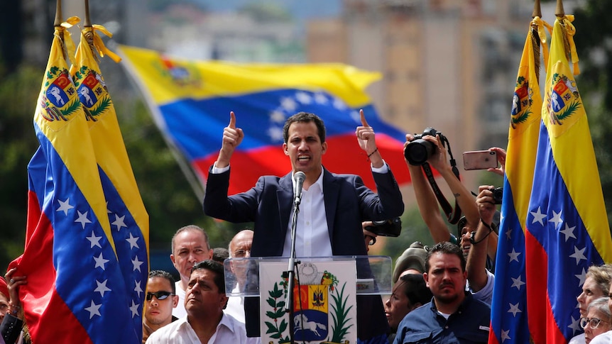 Juan Guaido, head of Venezuela's opposition-run congress, declares himself interim president of the nation at a rally.