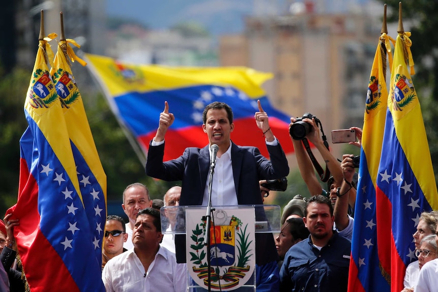 Juan Guaido, head of Venezuela's opposition-run congress, declares himself interim president of the nation at a rally.