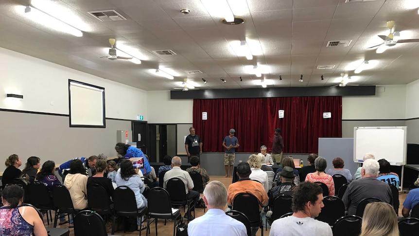 Gomeroi people sitting in hall giving oral submissions during public consultation of Aboriginal heritage concerns