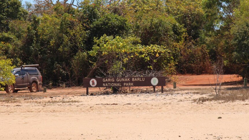 A wideshot of Garig Gunak Barlu national park, including the sign.
