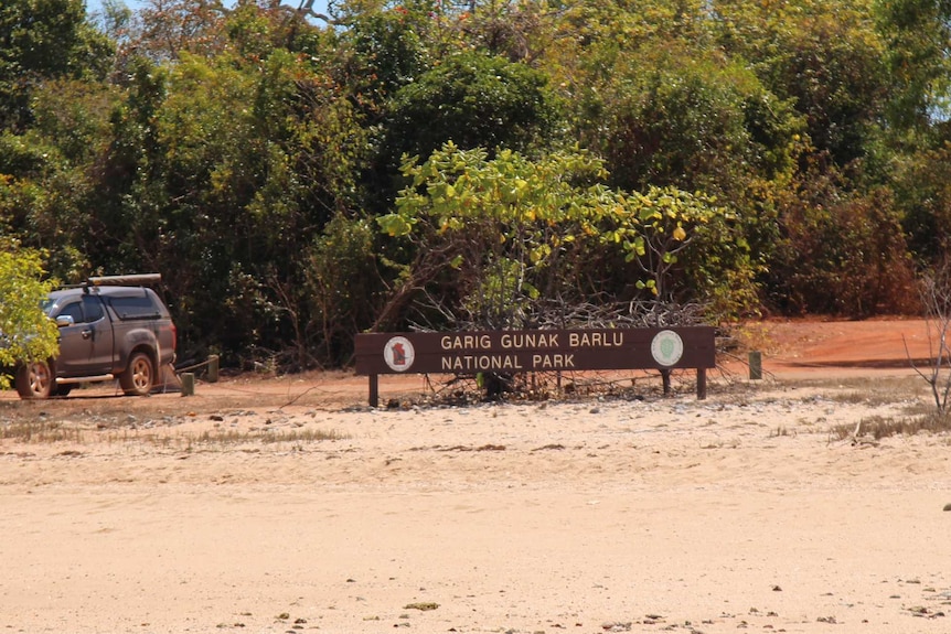 A wideshot of Garig Gunak Barlu national park, including the sign.