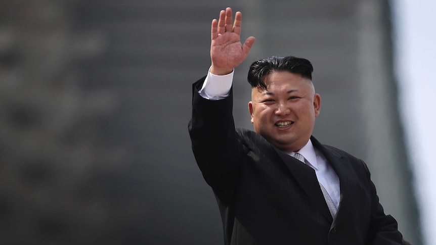 North Korean leader Kim Jong-Un waves during the military parade on Saturday.